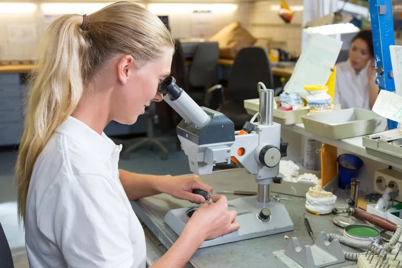 Woman working in dental laboratory